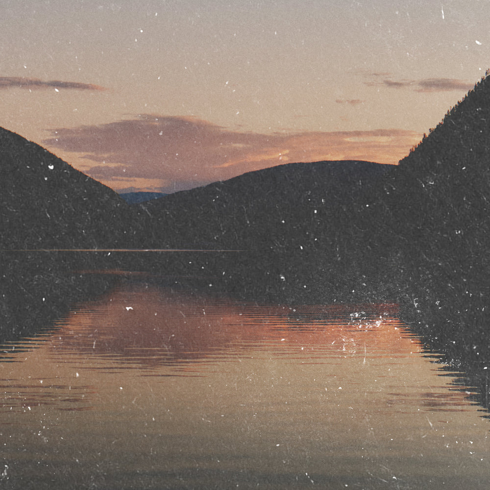 Blog image scenic view of the sunset over the water where it meets the mountains. | To The Next Journey