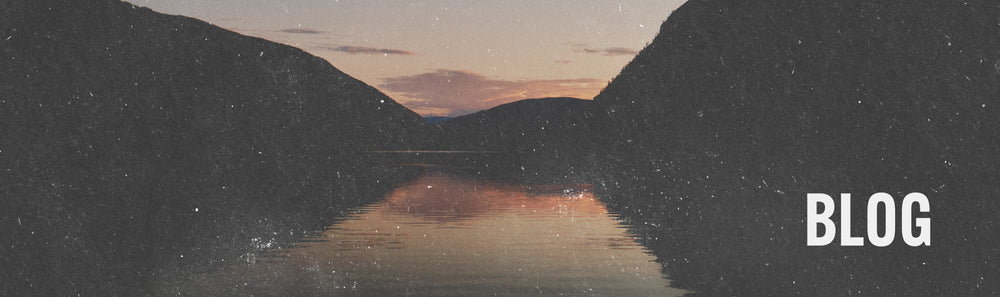 Blog image scenic view of the sunset over the water where it meets the mountains. | To The Next Journey